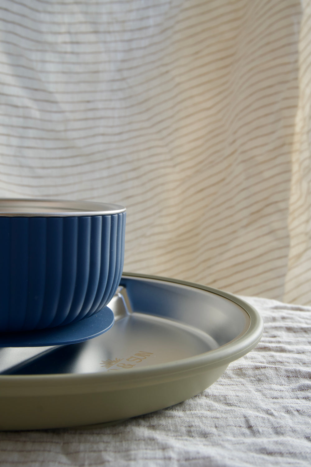 Stainless steel plate, bowl, and cup.