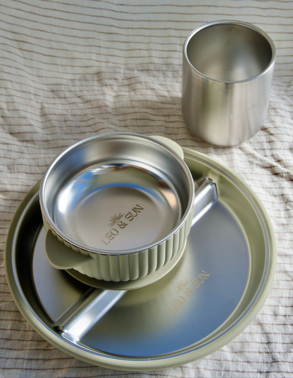 Stainless steel餐具 set with cup on a textured surface