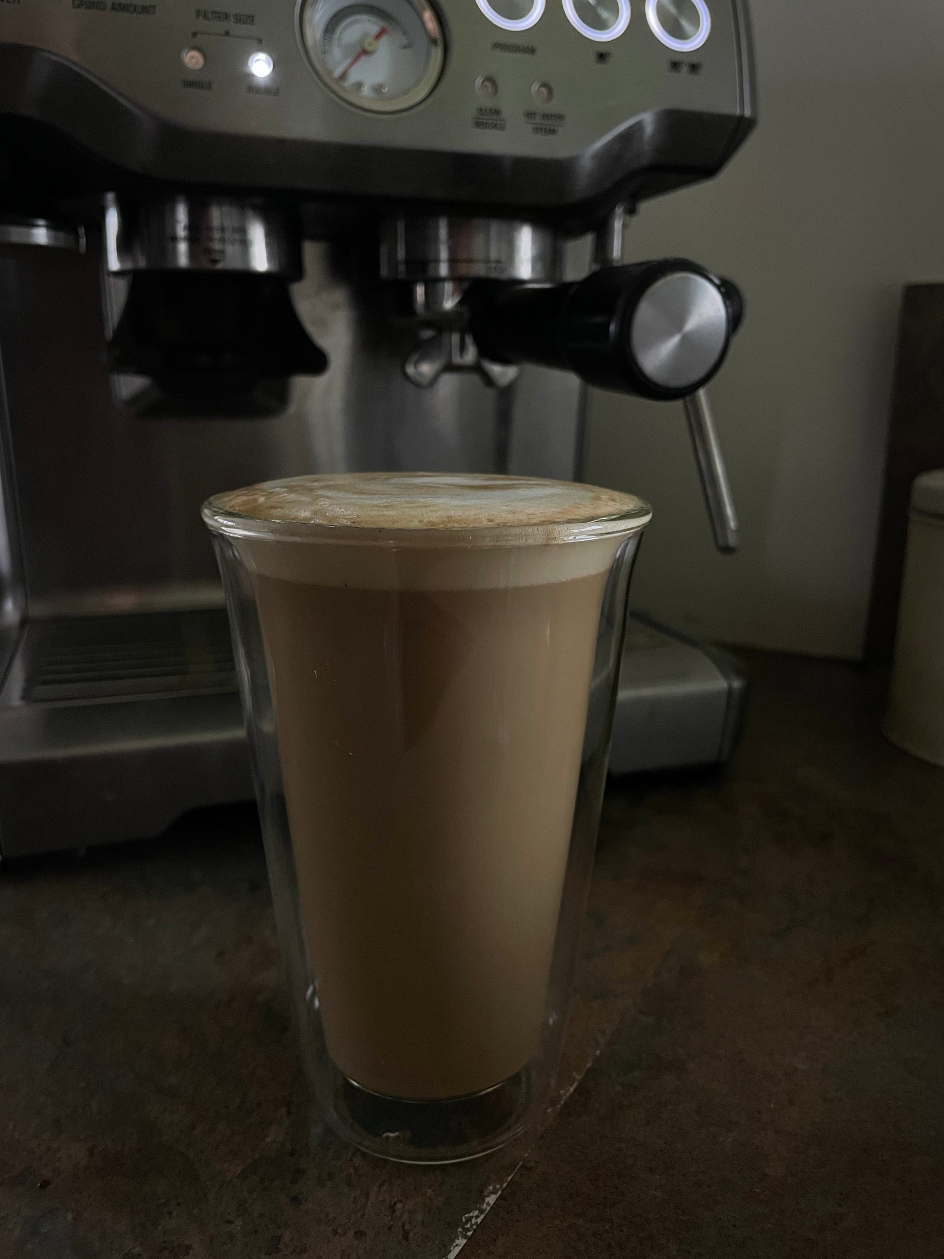 Espresso machine with a glass of coffee on a countertop