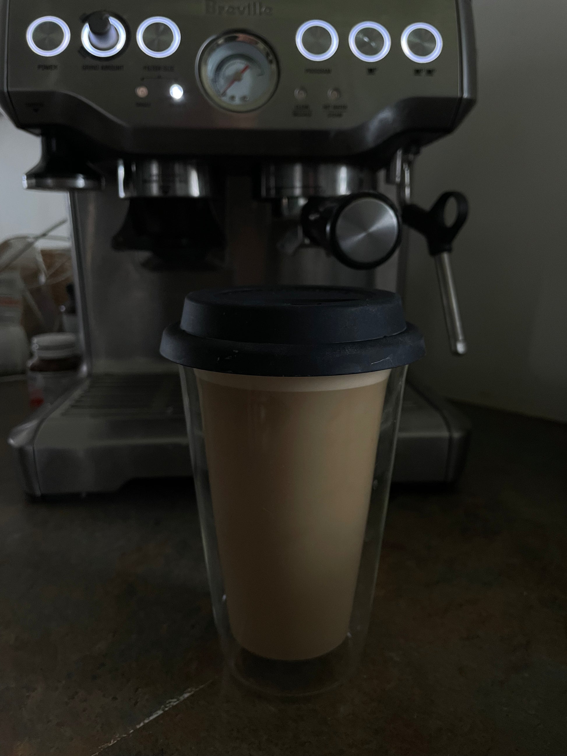 Espresso machine with a glass cup in front