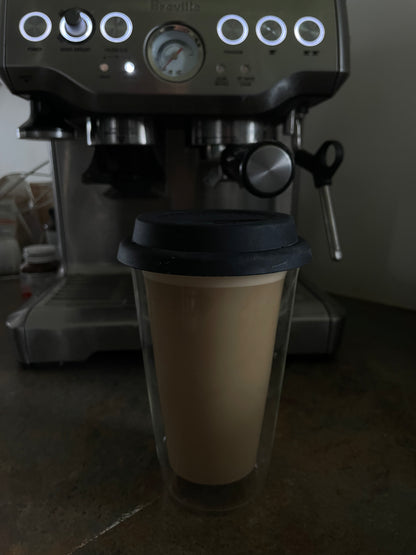 Espresso machine with a glass cup in front
